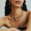 A hardstone cameo necklace and a pair of earrings in gold with enamel and set with pearls